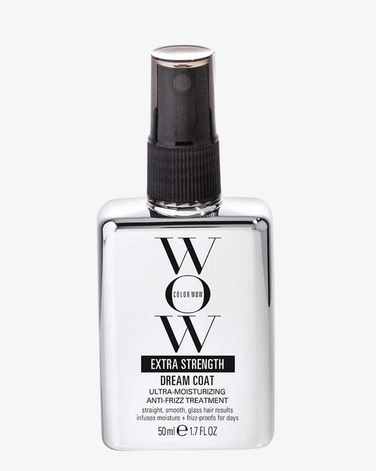 A bottle of WOW Color Wow Extra Strength Dream Coat hair treatment spray, featuring a clear rectangular bottle with a black spray nozzle and a white label, set against a light gray background.