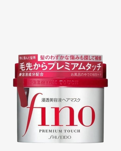 Shiseido Fino Premium Touch hair mask container with a white body, red lid, and red Japanese text on the label, shown against a light gray background.